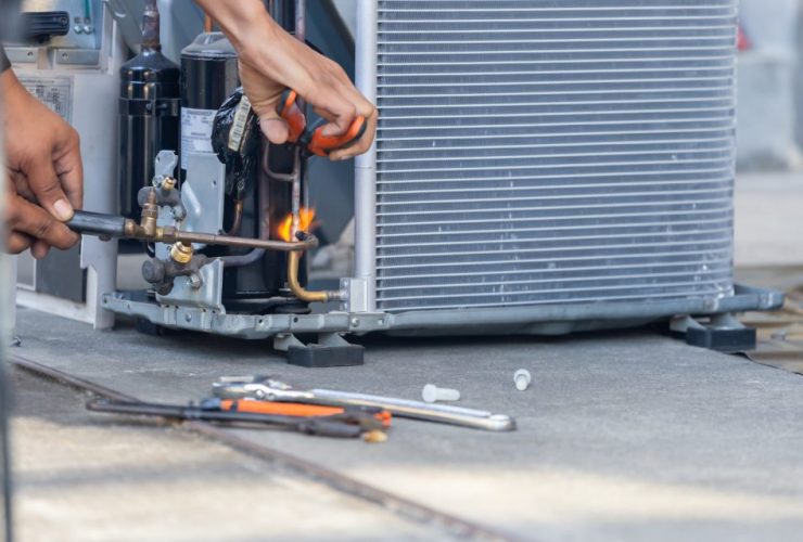 What is an f gas - man fixing a HVAC Unit - f-gases