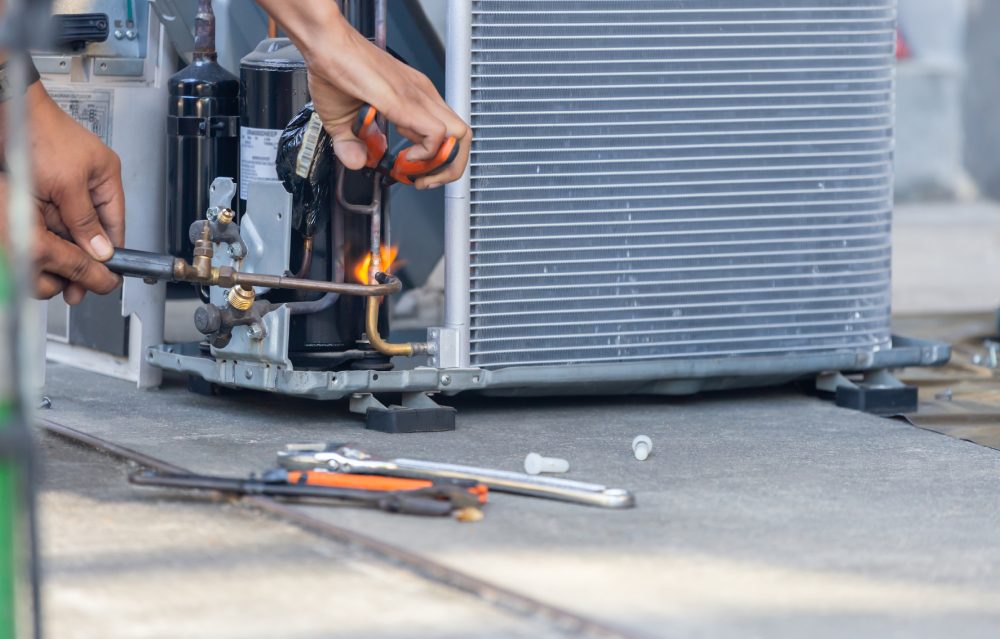 What is an f gas - man fixing a HVAC Unit - f-gases