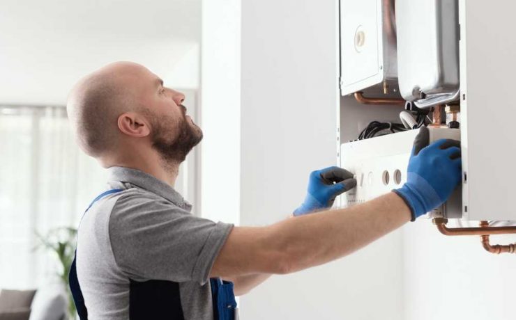 self employed gas engineer fixing a boiler
