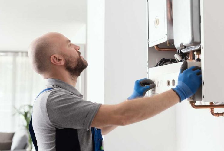 self employed gas engineer fixing a boiler
