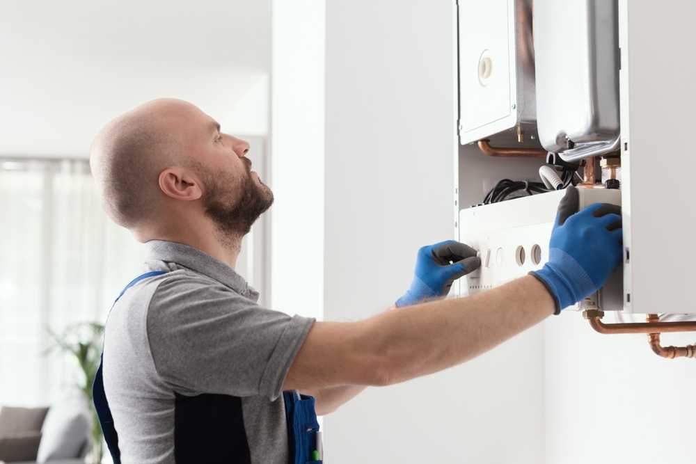 self employed gas engineer fixing a boiler