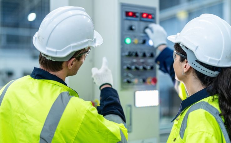 woman and man lookig at electrical control panel during electrical installation training