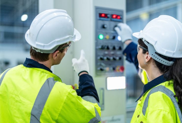 woman and man lookig at electrical control panel during electrical installation training
