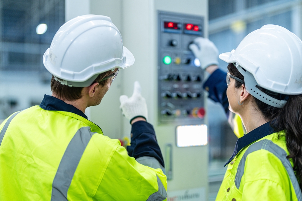 woman and man lookig at electrical control panel during electrical installation training