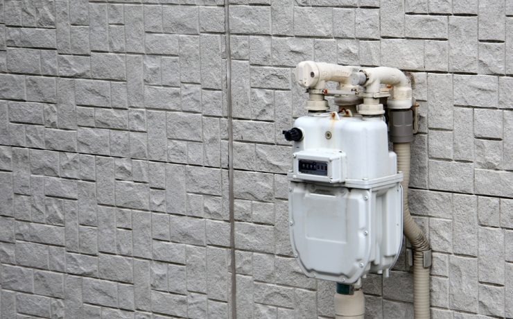gas meter installations - gas meter on a white brick wall
