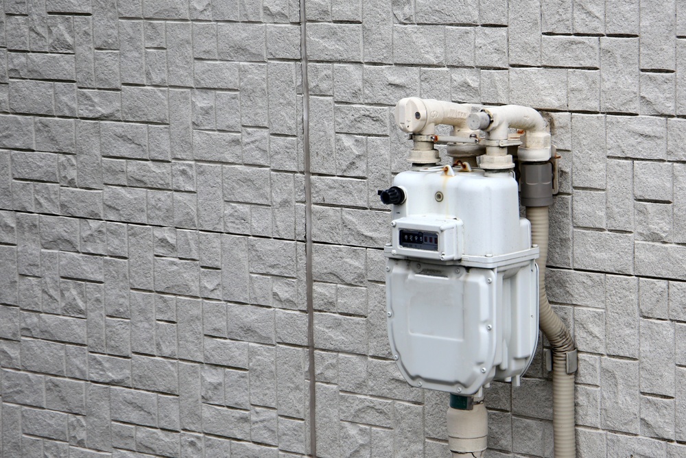 gas meter installations - gas meter on a white brick wall