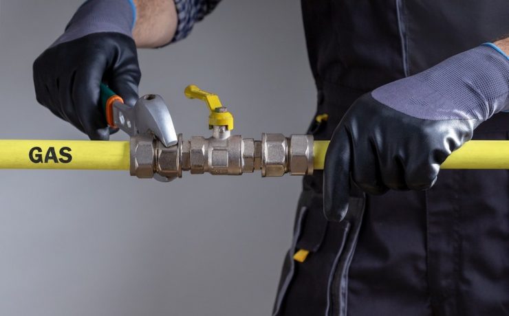gas engineer working on pipe work close up of mans hands