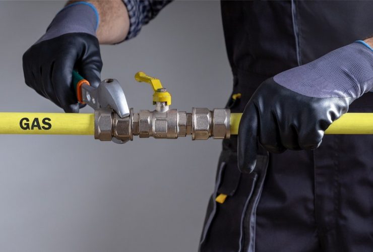 gas engineer working on pipe work close up of mans hands