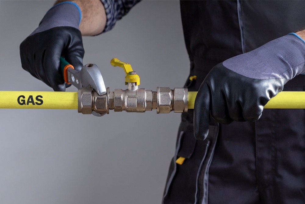 gas engineer working on pipe work close up of mans hands